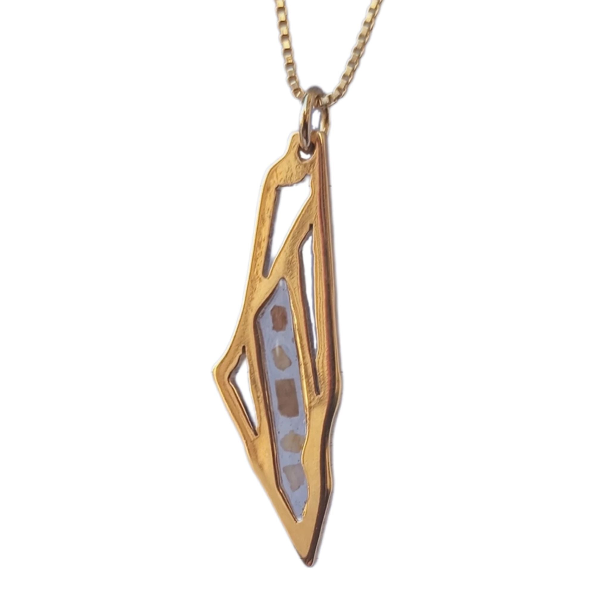 Woman wearing the Palestine map necklace, showing how the pendant sits when worn