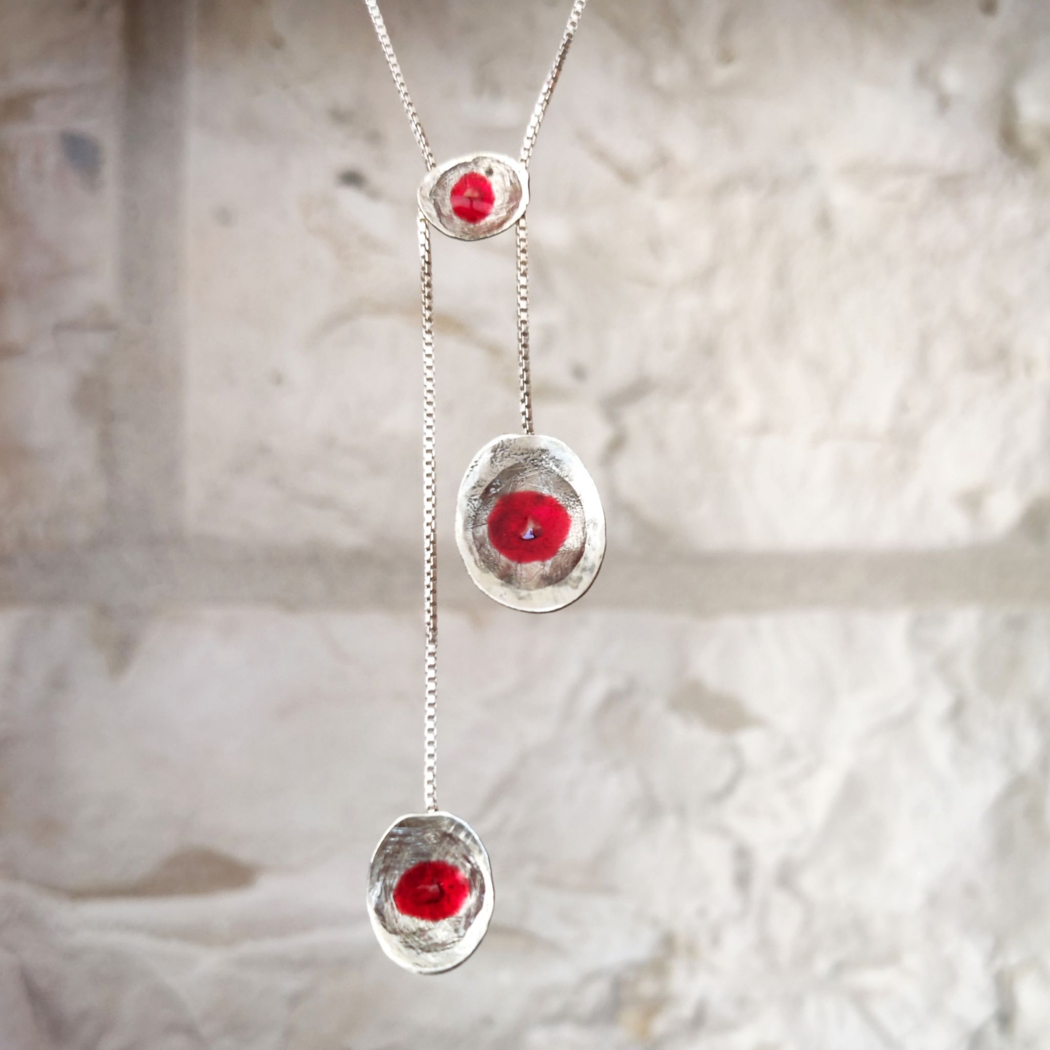  The Vineyard Necklace worn by a model , handmade in Palestine